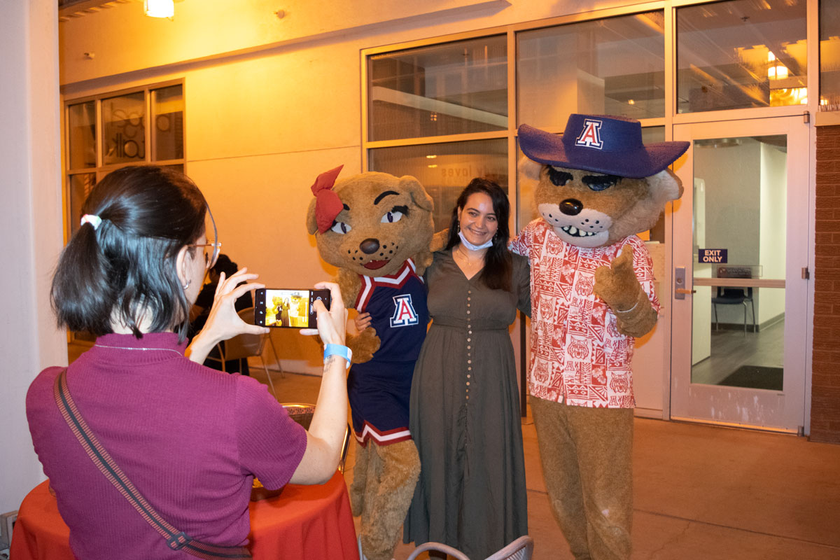 Party at Global Fall 2021 - Student getting photo taken with Wilbur Wildcat Party at Global Fall 2021 - Student getting photo taken with Wilbur Wildcat