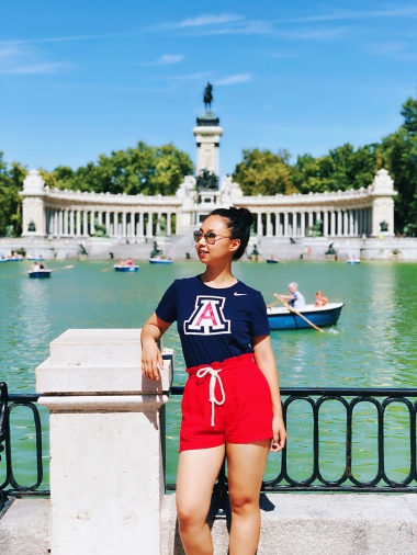 Mandy Han, studying abroad in Madrid, Spain, wearing UArizona shirt and colors, fountain in background
