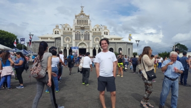 UA Study Abroad Student Brenden Barness standing in a populated town square in Costa Rica with a Basilica behind him UA Study Abroad Student Brenden Barness standing in a populated town square in Costa Rica with a Basilica behind him