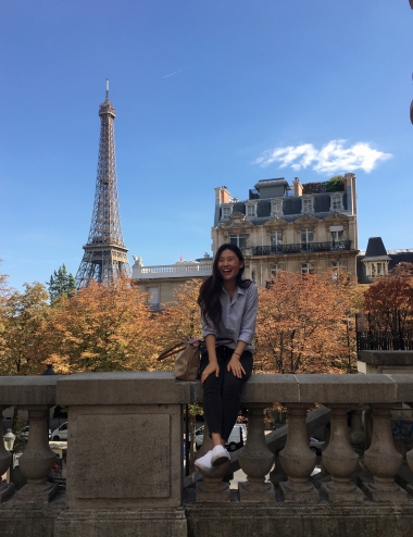 UA Study Abroad Student Stephanie Kim sitting on a wall in Paris with the Eiffel Tower in the background. UA Study Abroad Student Stephanie Kim sitting on a wall in Paris with the Eiffel Tower in the background.