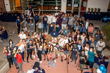 International students group photo with Wilbur and Wilma Wildcat at the 2021 Global Wildcat Welcome Party