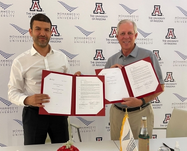 UM6P President Hicham El Habti at left, and UArizona President Robert C. Robbins at right, each holding signed copies of the MoU
