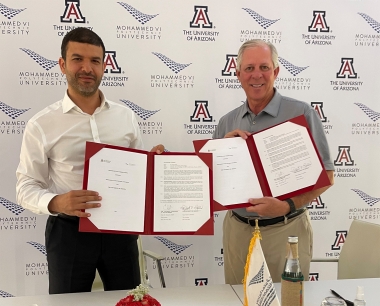 UM6P President Hicham El Habti at left, and UArizona President Robert C. Robbins at right, each holding signed copies of the MoU UM6P President Hicham El Habti at left, and UArizona President Robert C. Robbins at right, each holding signed copies of the MoU